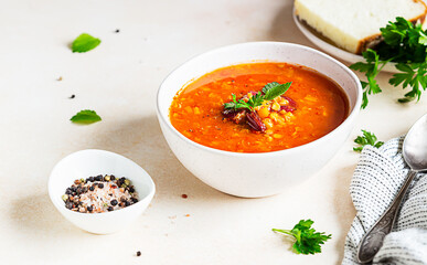 Homemade thick lentil and red bean soup with vegetables garnish with herbs. Fit and healthy, vegetarian and vegan meal.