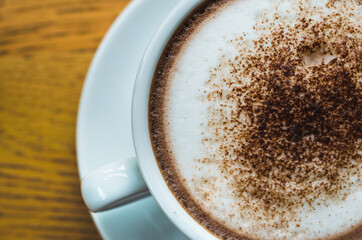 closeup coffee cup on wood table bar in restaurant or cafe with copy space. fresh beverage.