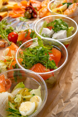 catering table. Furshet. A variety of salads in plastic cups