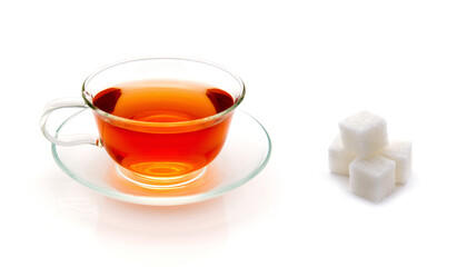 Black tea with sugar cubes isolated on white background