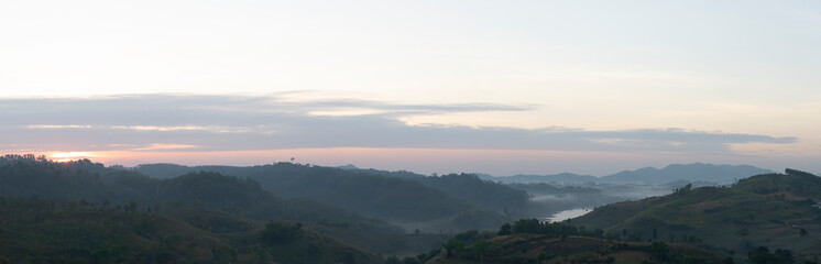 Mountain landscape with beautiful forest with fog and clouds.