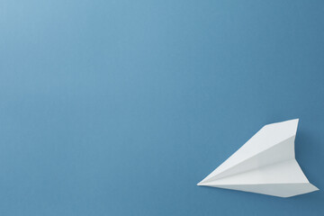 White paper airplane on a blue background