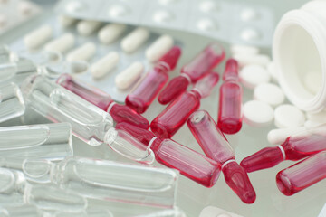 Tablets pills ampoules on a glass table