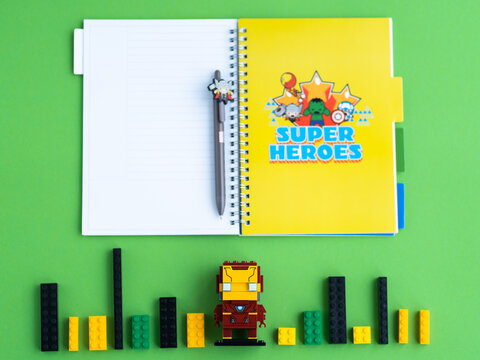 Minsk, Belarus. December, 2020. Popular Super Heroes Marvel. Iron Man. Notebooks, copybook, pen, Lego constructor. Education and school background.