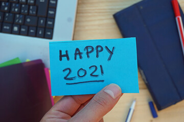 Happy 2021 written on a memo at the office