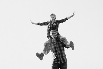 Cheerful guy and girl on a walk in bright knitted hats