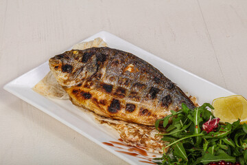 Grilled dorada fish served lemon