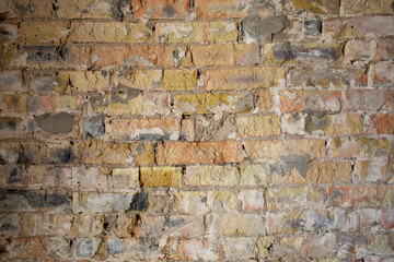 Old yellow damaged brick wall beautiful background
