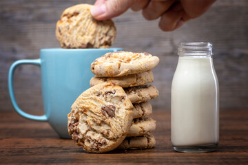 Milk and chocolate chip cookies, dunking into tea.