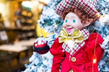 Fototapeta premium Closeup Christmas Tree ornaments, balls, toy and fairy lights. Christmas and New Year celebration
