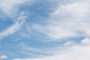 White Cirrostratus clouds against blue sky in sunny day.