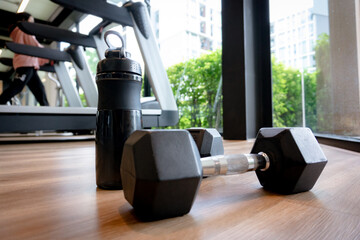 dumbbell and water bottle in gym