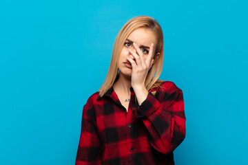young blonde woman feeling bored, frustrated and sleepy after a tiresome, dull and tedious task,...