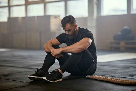 Man resting after a battle rope workout