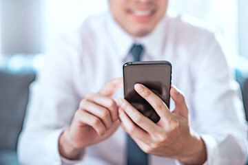 Happy businessman using mobile smartphone. Copy space.