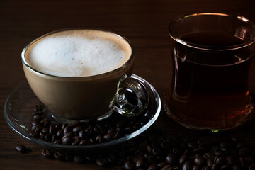 Hot coffee and hot tea on the floor of a wooden table.