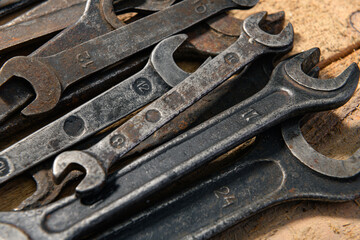 Obraz na płótnie Canvas old vintage hand tools - set of wrenches on a wooden background