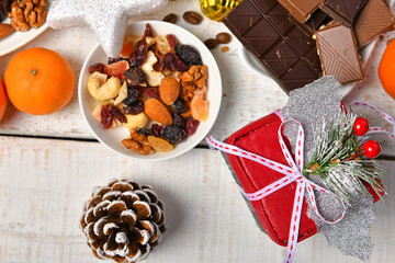 sweet food top view background for merry christmas or new year holiday decoration - chocolate candies, tangerines, cookies on white wood