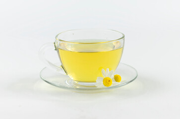 glass cup of chamomile tea on a white background.