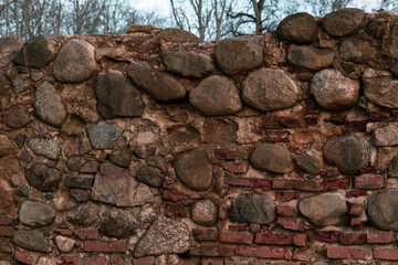 Old masonry wall of stones and bricks