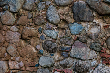 Old masonry wall of stones and bricks