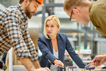 confident female investor explain to architect and engineer what she wants, need from them, they...
