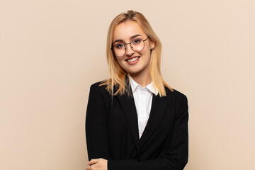 young blonde woman laughing shyly and cheerfully, with a friendly and positive but insecure attitude