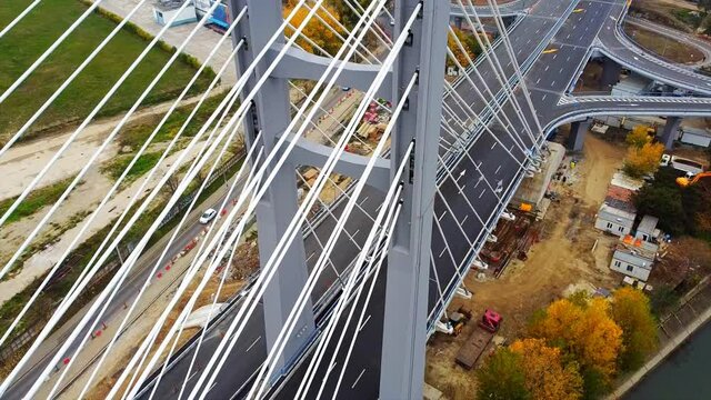 Ciurel passage, bridge over a river with moving cars, construction works near it. View from the drone. Bucharest, Romania