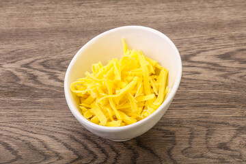 Shredded yellow cheese in the bowl