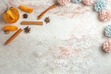 palms and cinnamon sticks and anises and flowers on the marble background