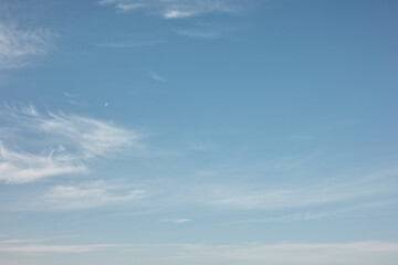 moon in blue sky with clouds