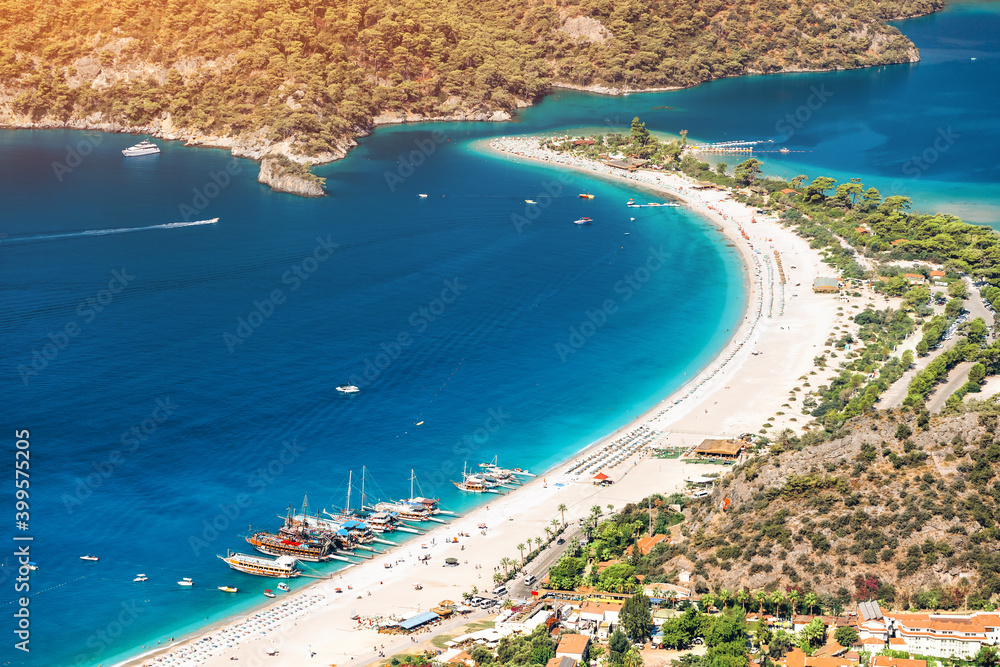Wall mural famous and popular Turkish resort town of Oludeniz, aerial view of a fantastic sand bar and a bay with turquoise water. Vacation and beach holiday concept - Wall murals