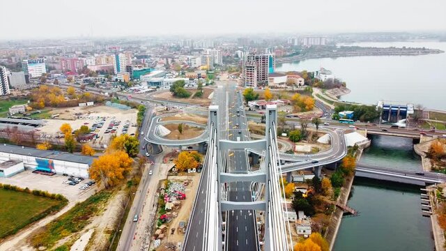 Ciurel passage, bridge over a river with moving cars, construction works near it. View from the drone. Bucharest, Romania