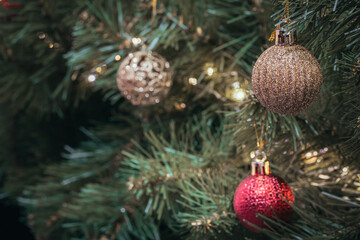Christmas tree holidays decoration of red and gold balls with pinecones