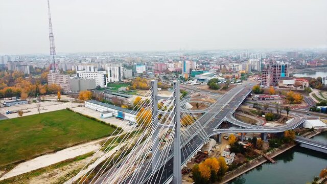 Ciurel passage, bridge over a river with moving cars, construction works near it. View from the drone. Bucharest, Romania