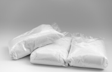 Fototapeta na wymiar Sugar in packages on white background