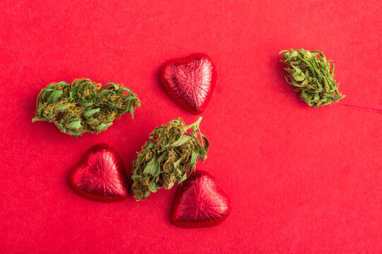 Cannabis Infused Chocolate Hearts Wrapped In Foil For Valentines Day On Red Background