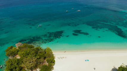 Tropical white sand beach in a lagoon with turquoise water on Boracay Island, Philippines, aerial...