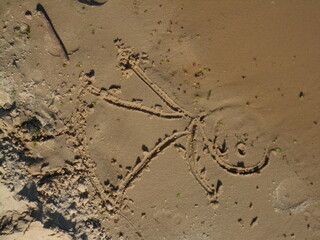Child&rsquo;s drawing on the sandy beach