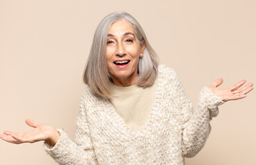 middle age woman looking happy, arrogant, proud and self satisfied, feeling like a number one