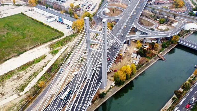 Ciurel passage, bridge over a river with moving cars, construction works near it. View from the drone. Bucharest, Romania