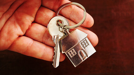 Close up key house on hand