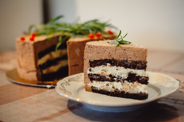 A delicious piece of chocolate cake with cream and pear, on a white plate. Sliced mousse cake. Film...