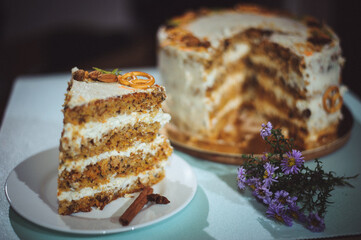 Carrot cake with nuts, prunes and dried apricots . Purple flowers, bouquet.