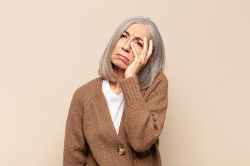 middle age woman feeling bored, frustrated and sleepy after a tiresome, dull and tedious task,...