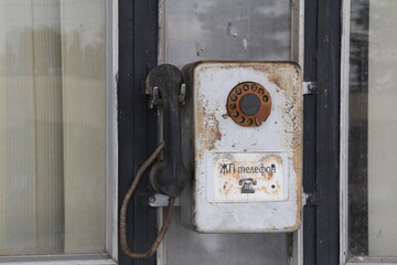Fototapeta na wymiar old landline phone, worn, rusty, with receiver and dial