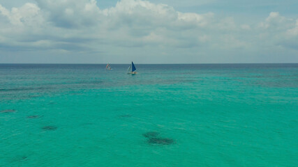 Sailing yacht in lagoon turquoise water, aerial view. Sailing boat glides over the waves, Summer...
