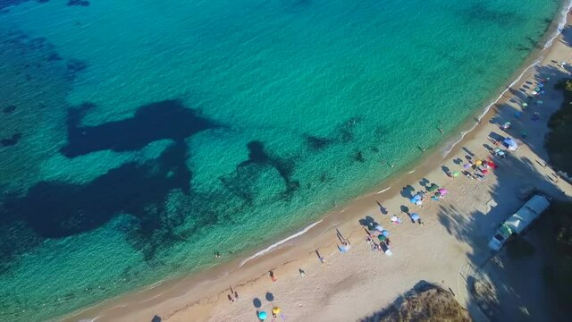 Timelapse Hyper-lapse Rising top down orbit shot of promontory cape headland foreland nature Sardinia coast Sardinian landscape Baccu Mandara beach mediterranean sea aerial drone shot beach resort