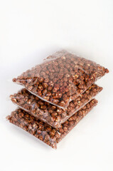 Caramel chocolate brown popcorn in a package on a white background