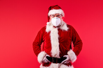 santa claus father in medical protective mask, having party time during coronavirus covid-19 in 2021 new year, xmas concept.